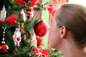 Child girl looking at Christmas Tree