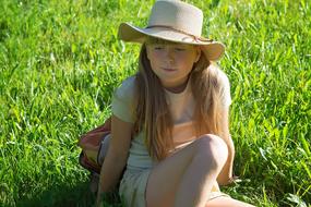 Girl in hat green grass