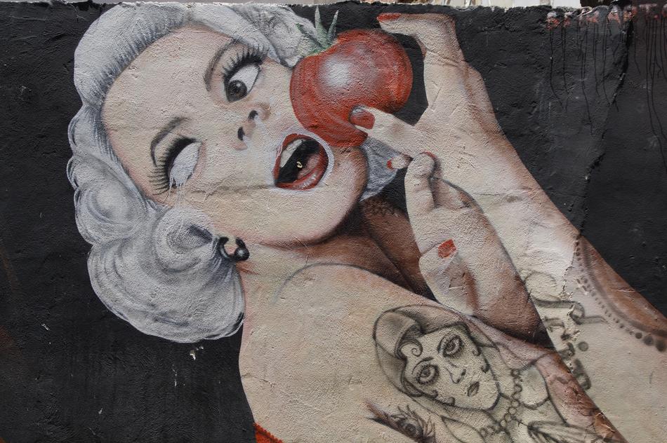 Graffiti girl with a tattoo on the wall