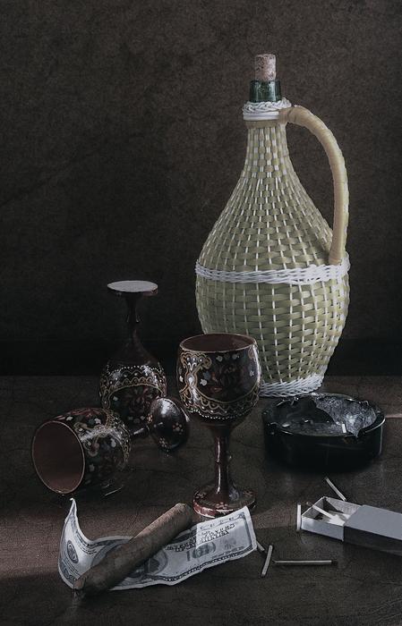 a bottle of wine on the table with glasses.