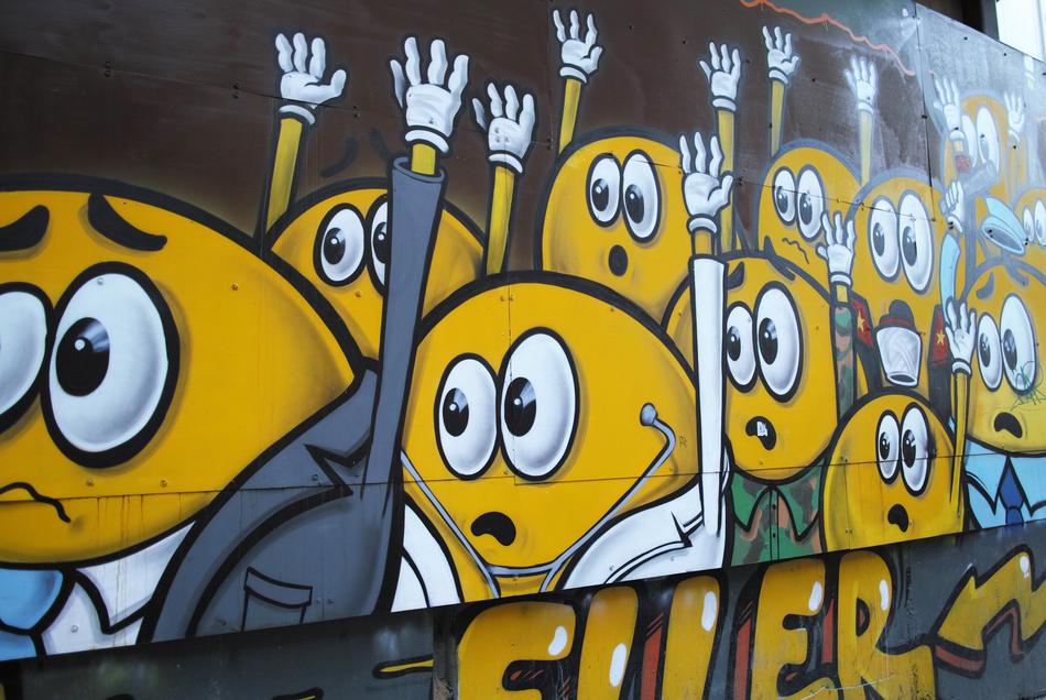 crowd of smileys hands up, graffiti