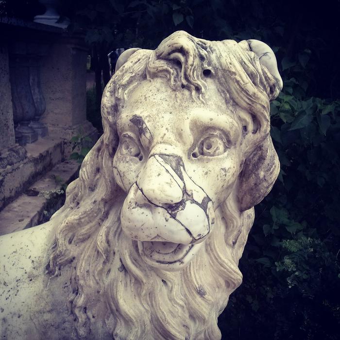broken lion sculpture