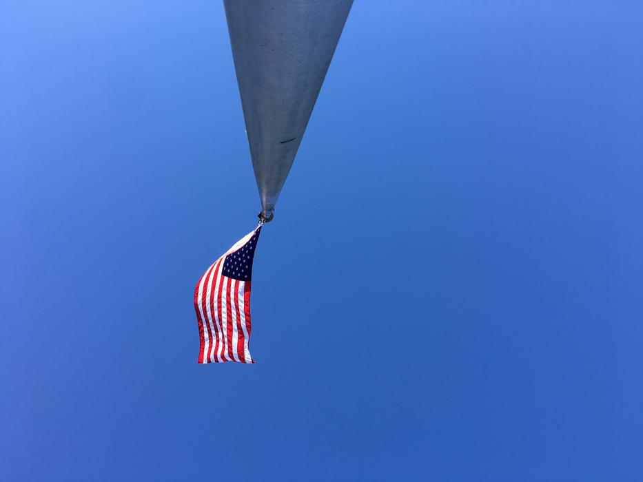 a colored flag on a long roof