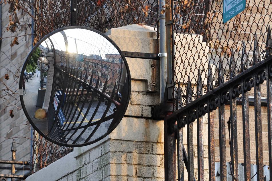 mirror near the metal fence for safety