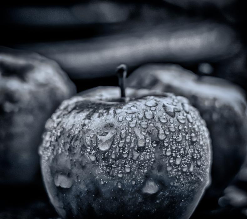 gray apple in water droplets