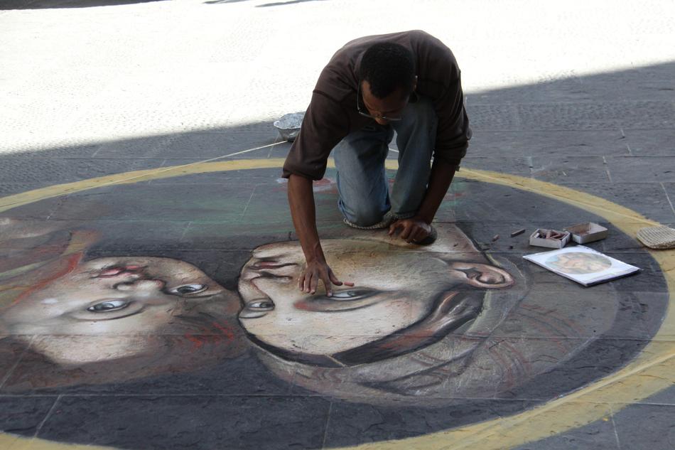 man wipes down a painting