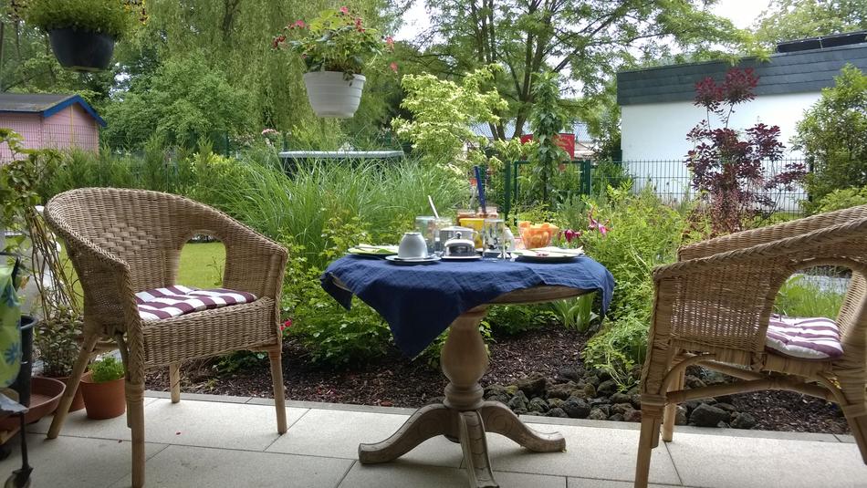 a cozy table and chair in the backyard