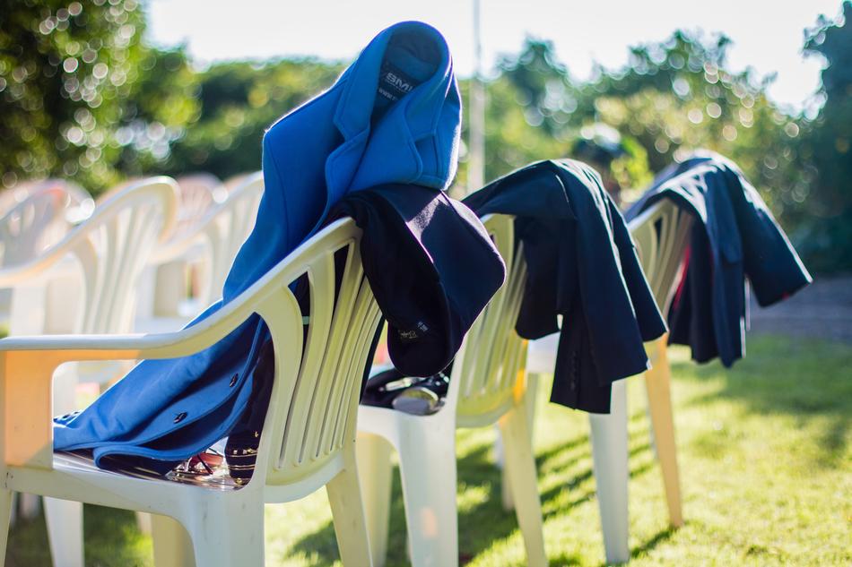 coats and jackets on chairs in the park