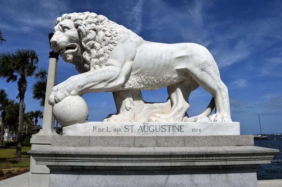 sculpture of a lion with a ball