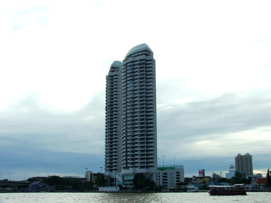 open ship on the background of a tall building on the waterfront
