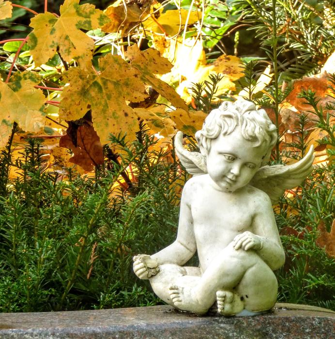 sculpture of a little angel in the garden