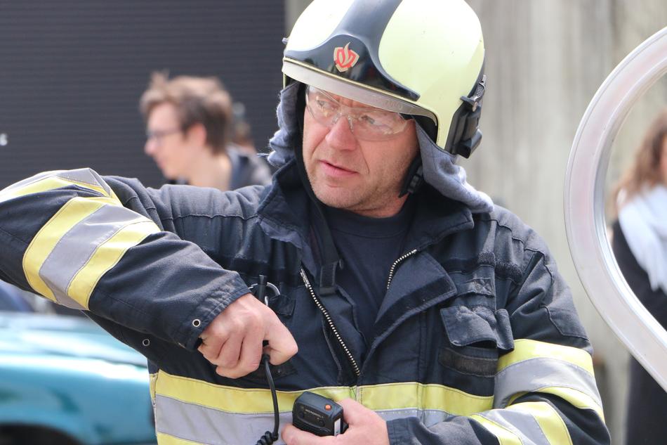 a male lifeguard with a hose