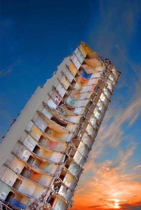 bottom view of a tall building at sunset