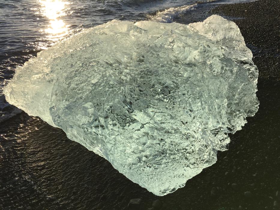 a big chunk of ice on the beach