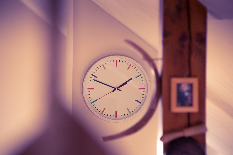 wall clock in pink blurred background