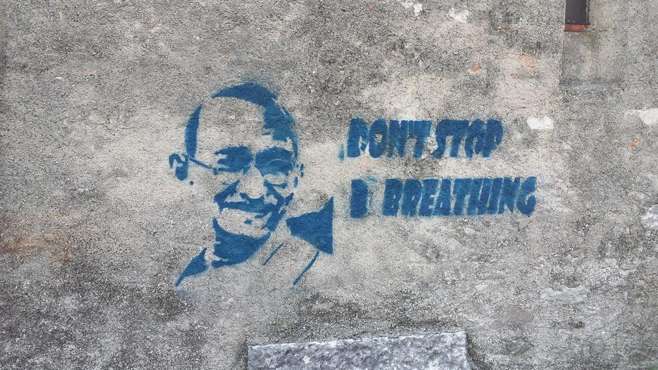 the man with the blue writing on the wall.
