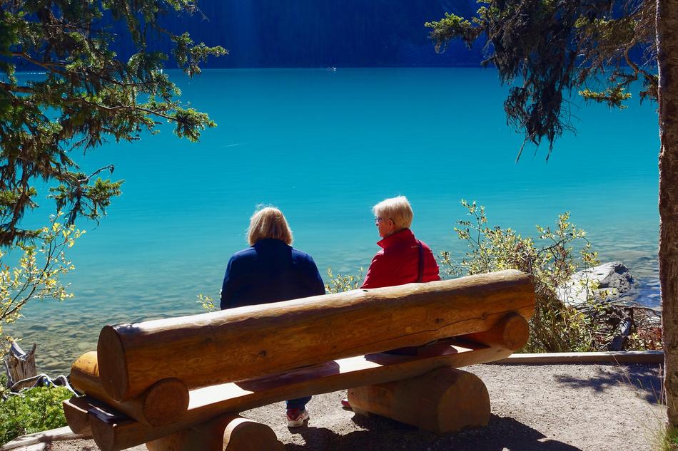 A cute couple on a bench by the water
