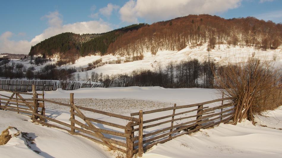snowy mountains by the fence