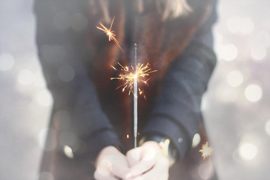a girl with a sparkler in her hand.