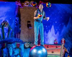 male Juggler with balls on stage