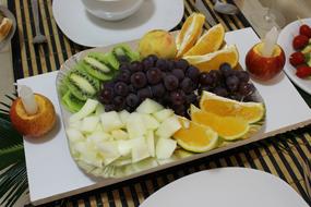 slicing fruit on a plate on the table