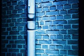 drain pipe at brick Wall, Blue background