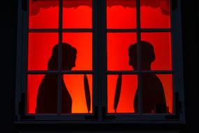 silhouette of people on a red background