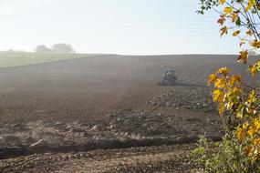 Agricultural machine on the arable field, on the beautiful landscape