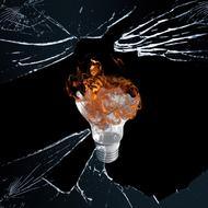 Light bulb with the flame, among the broken glass, at black background, clipart