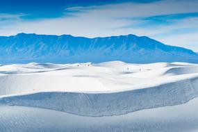 Beautiful scenic landscape with the desert and blue mountains on background