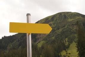 yellow sign on an iron pole