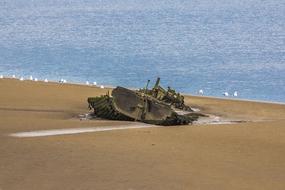 old ship on the beach by the sea