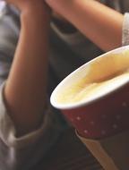 frothy coffee in a red cup