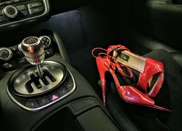 red High Heels shoes inside luxury Car