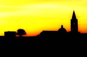 silhouette of the tower and dome against the yellow evening sky