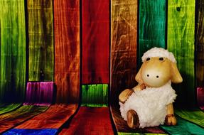 white Sheep, Funny figurine sits on colorful boards