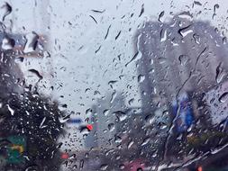 Beautiful view of the city, through the glass with rain drops