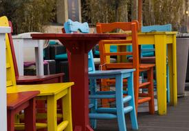 colored chairs and tables made of wood