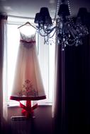 dresses on a hanger by the window