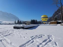 yellow ball on white snow