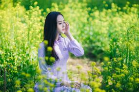 photo of an asian girl in a flowering meadow