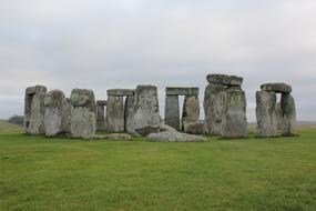 green grass with stones on a background of clouds