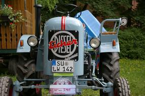 Colorful "Eicher" tractor on the colorful meadow, near the colorful plants