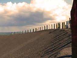 sandy beach with wooden pillars