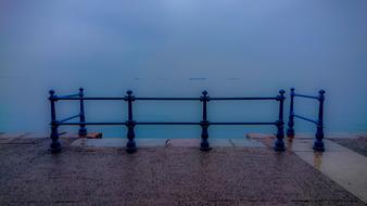 the blue sea with a fence