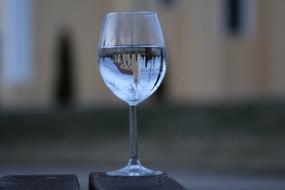 reflection of a building in a glass of water