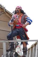 a man in a pirate costume on a ship