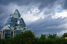 photo of a glass building on a background of clouds