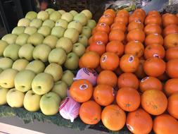 tangerines and apples on sale at the market