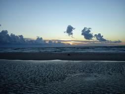 a water surface with a sandy beach